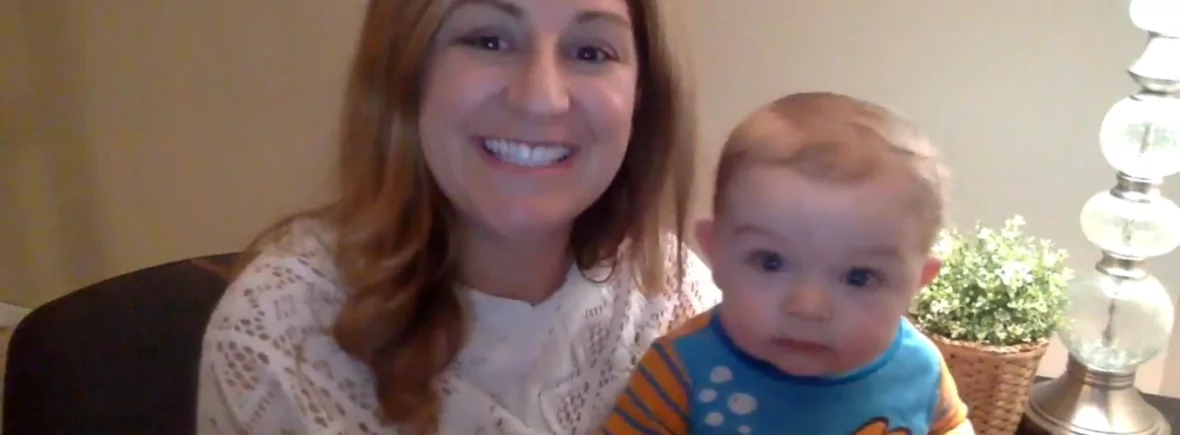 Smiling woman holding her baby.