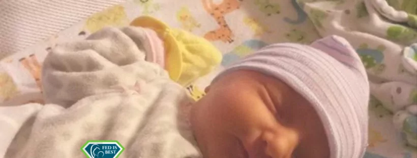 Sleeping newborn baby in bassinet.