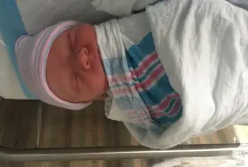 Newborn baby sleeping soundly in hospital.