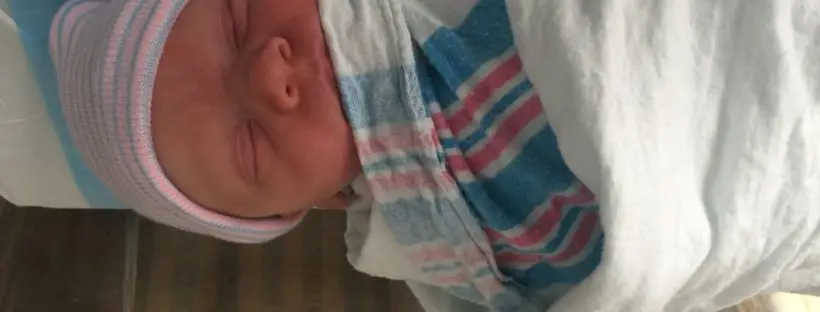 Newborn baby sleeping soundly in hospital.