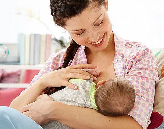 Mother breastfeeding her newborn baby.