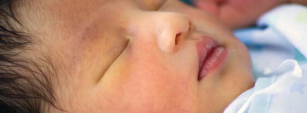 Sleeping newborn baby's face closeup.