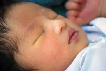 Sleeping newborn baby's face closeup.