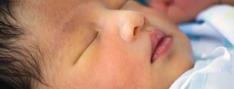 Sleeping newborn baby's face closeup.