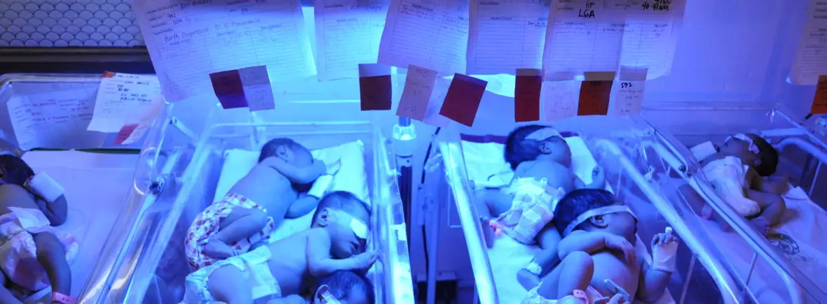 Newborn babies under UV light therapy.