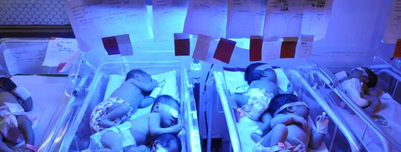 Newborn babies under UV light therapy.