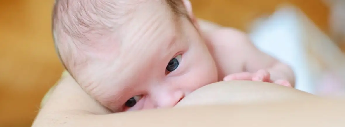 Newborn baby breastfeeding.