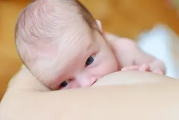 Newborn baby breastfeeding.