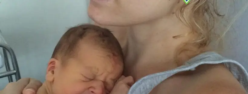 Mother holding and comforting crying newborn.