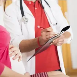 Here's an alt tag for the image: Doctor consulting pregnant patient.
