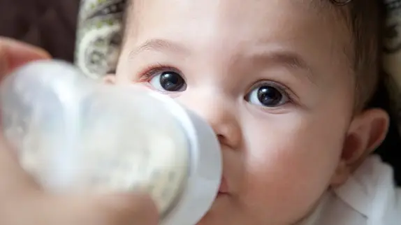 Baby drinking from a bottle.