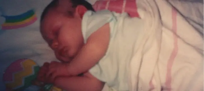 Baby sleeping soundly in crib.