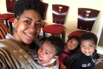 Happy mom with three adorable babies.