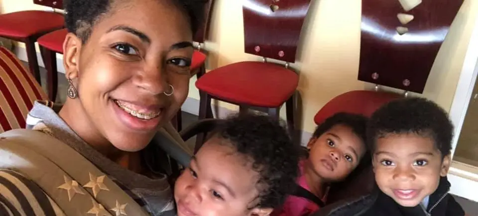 Happy mom with three adorable babies.